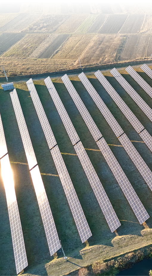 Aerial view of large sustainable electrical power plant with rows of solar photovoltaic panels for producing clean ecological electric energy. Renewable electricity with zero emission concept.