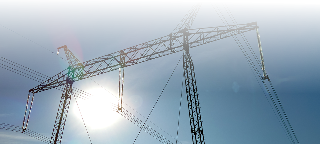 High voltage tower with electric power lines transfening electrical energy through cable wires.