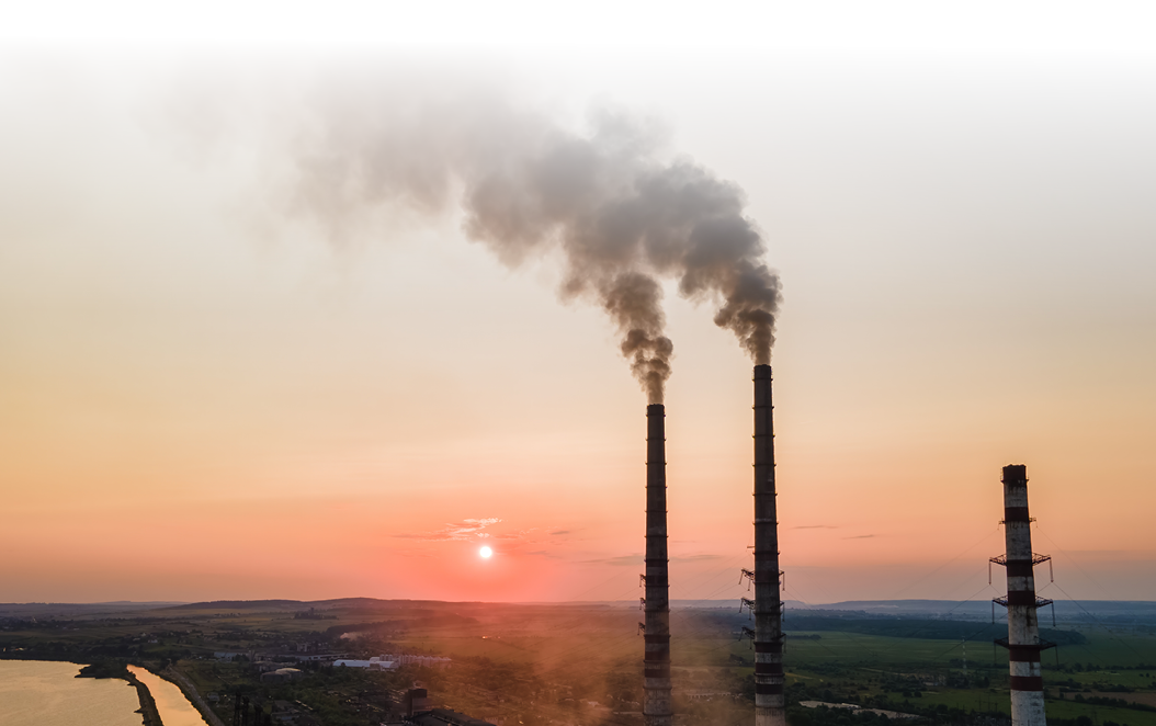 Aerial view of coal power plant high pipes with black smoke moving upwards polluting atmosphere at sunset. Production of electrical energy with fossil fuel concept.