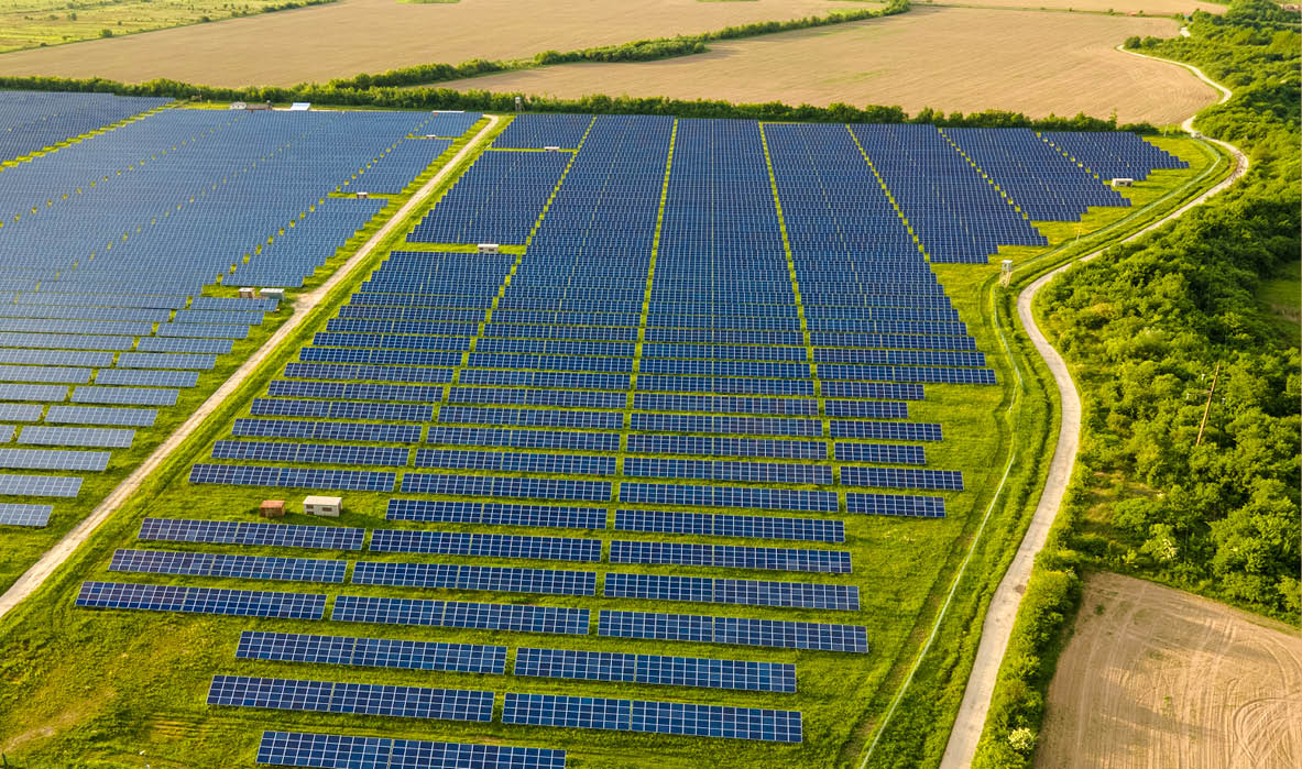 Aerial view of large sustainable electrical power plant with many rows of solar photovoltaic panels for producing clean ecological electric energy. Renewable electricity with zero emission concept.