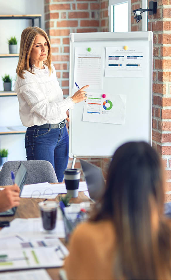 Group of business workers working together in a meeting  One of them making presentation to colleagues at the office