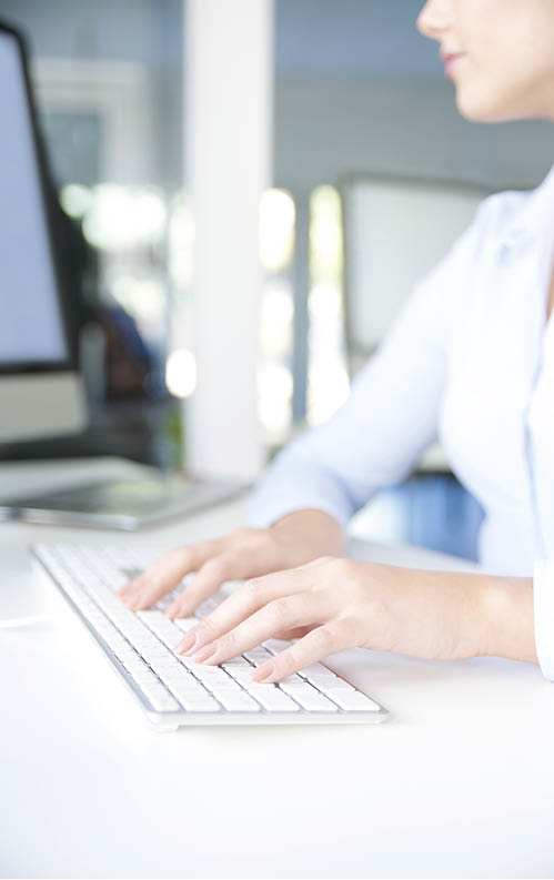 Shot of a woman s hands typing on her computer keyboard while sitting at office and working online 