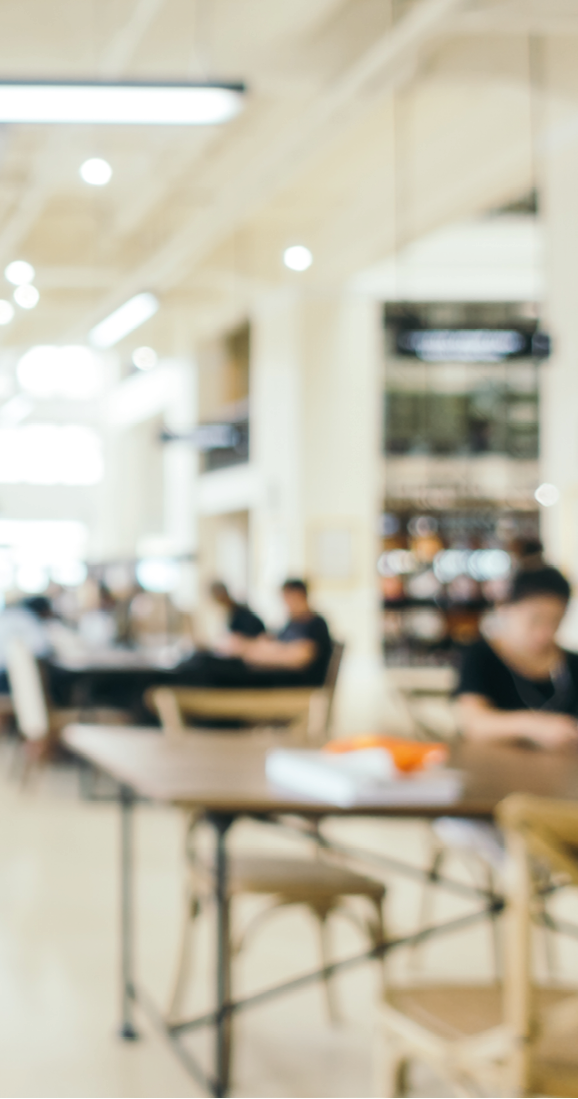 Abstract blur and defocused bookshelf in library interior for background