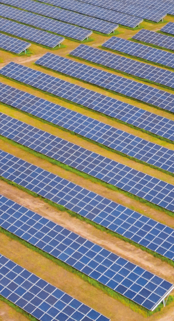 Solar panel produces green, environmentaly friendly energy from the setting sun. Aerial view from drone. Landscape picture of a solar plant that is located inside a valley