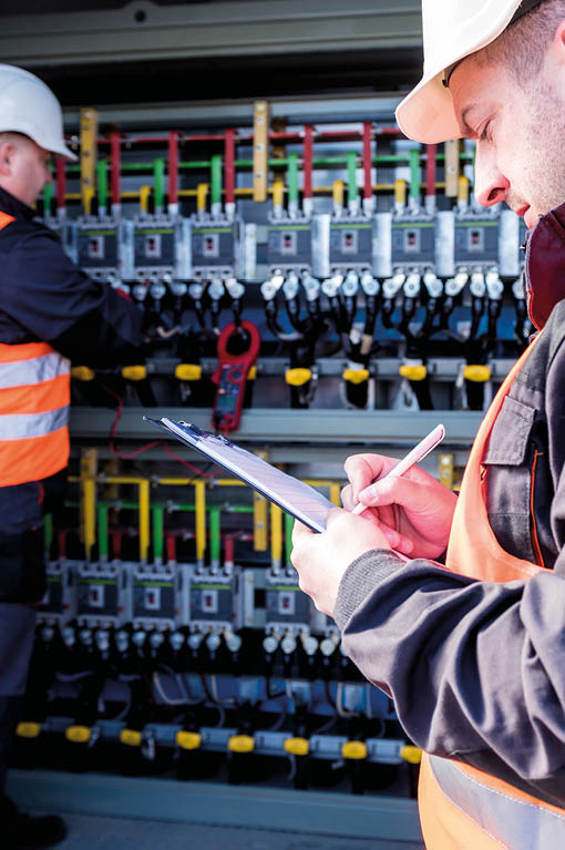 Checking the operating voltage levels of the solar panel switchgear compartment.