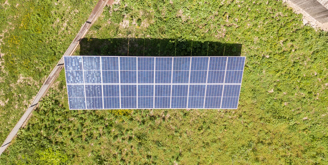 Aerial view of solar panels in rural country area.