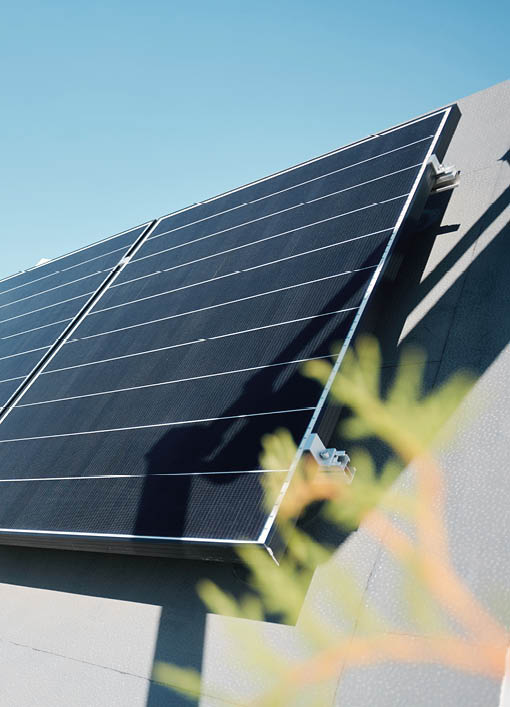 Large solar panels on rooftop of modern comfortable house or cottage in natural environment