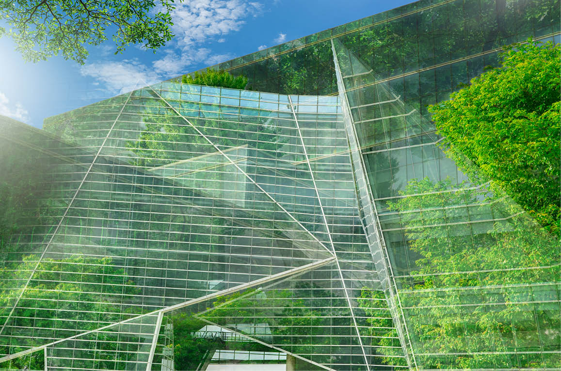 Sustainble green building. Eco-friendly building. Sustainable glass office building with tree for reducing carbon dioxide. Office with green environment. Corporate building reduce CO2. Safety glass.