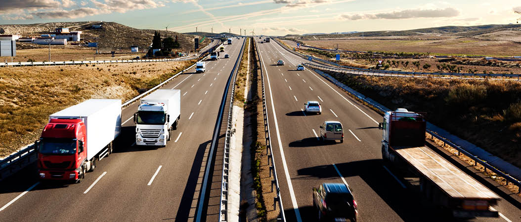 International shipment, trucks and cars driving on the road.Logistics and warehousing