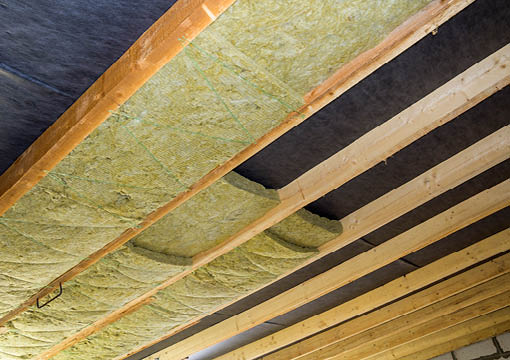 Thermal insulation mineral rock wool installation at the new building attic ceiling